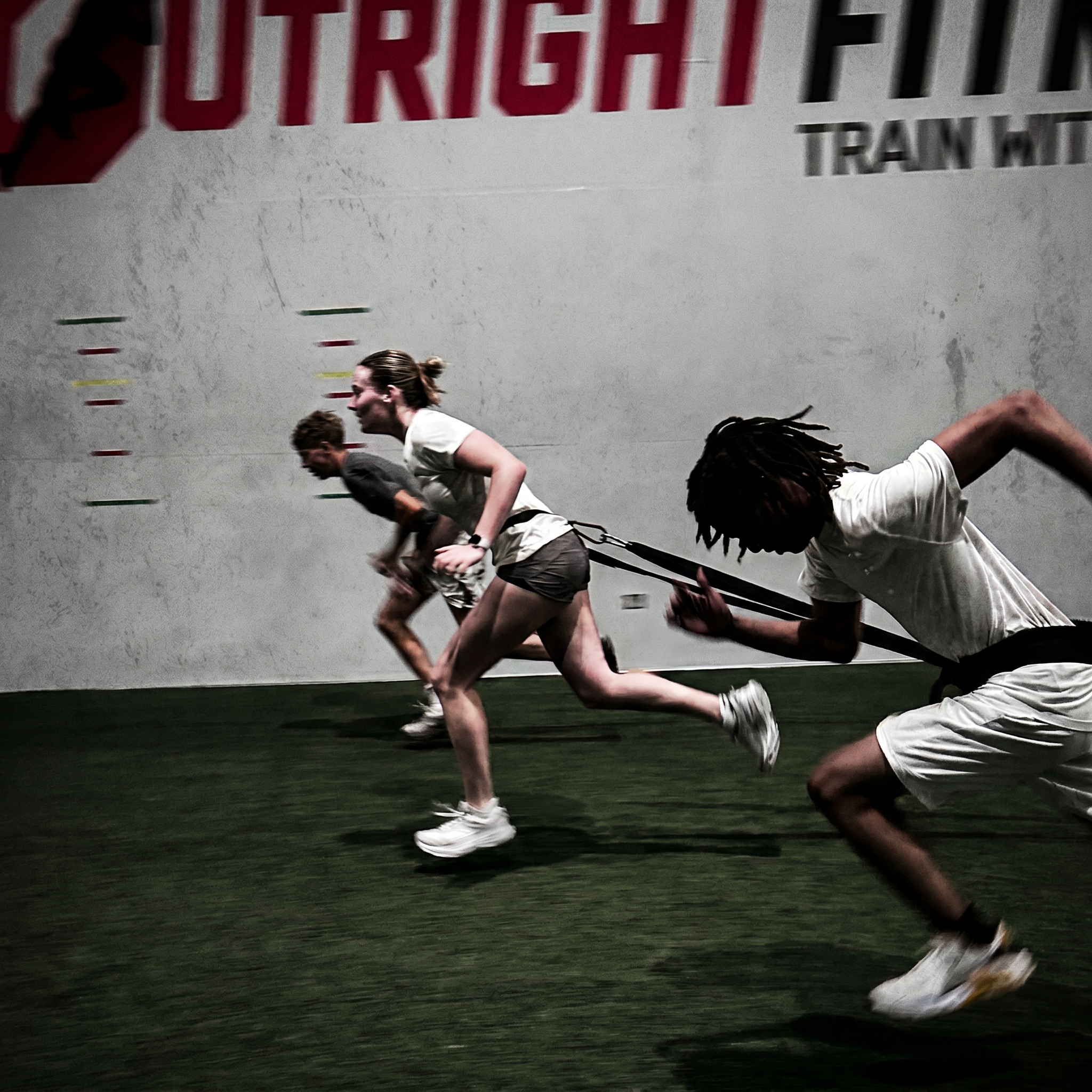 HS Programs High school teens speed training at an athletic gym.